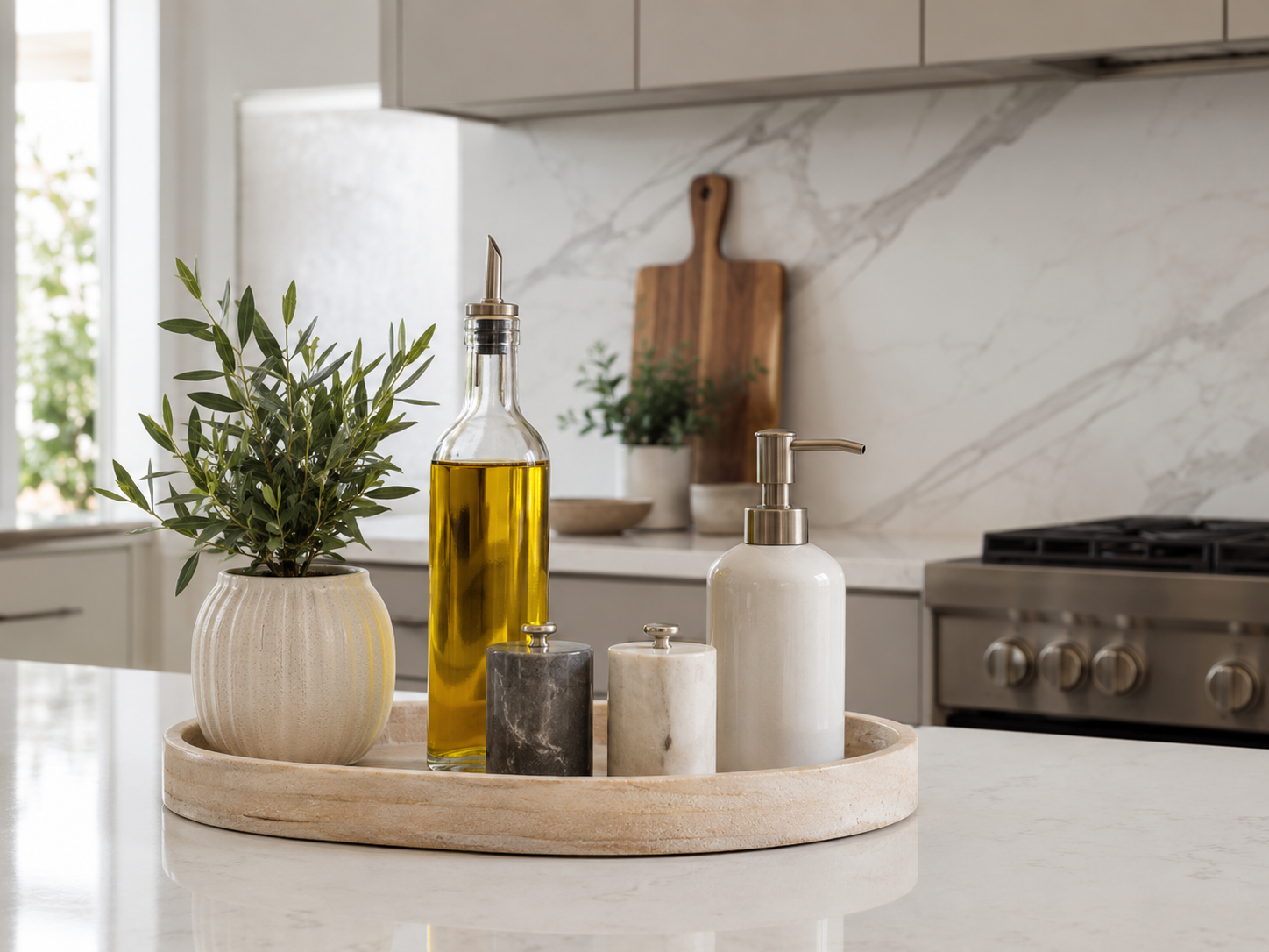 Modern kitchen countertop tray holding olive oil, salt and pepper, soap dispenser, and small plant on quartz or marble counter